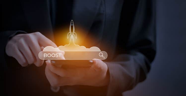 18 Ways to Write Better Blog Posts That Readers Will Finish 8 A person in a dark blazer holds a smartphone with a glowing search bar graphic that reads "BOOST" and features a rocket launching from behind it. This futuristic visual represents accelerating results or visibility, making it a strong metaphor for boosting traffic through better blog posts.