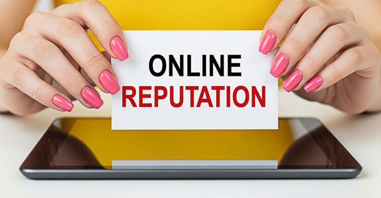 Hands with pink nails hold a white card that reads Online Reputation above a tablet on a yellow background. The image highlights the importance of managing perception and trust online to Improve Your Brand and influence how audiences see your business.