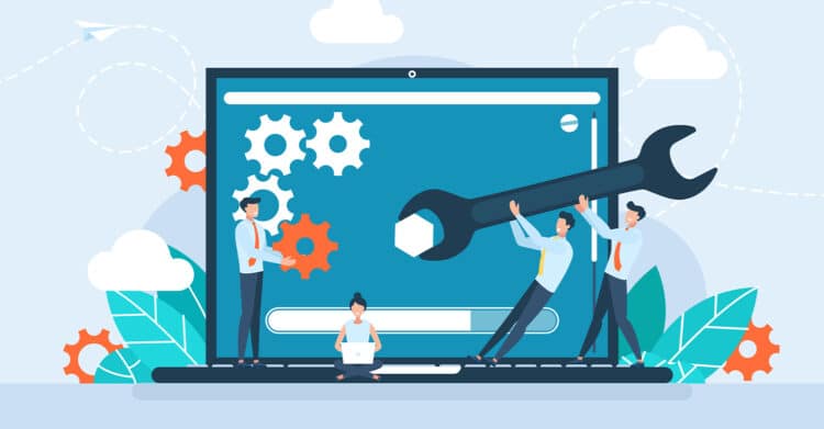 An illustration shows a team working together around a large laptop screen with gears and tools, including a wrench being lifted into place to fix systems. The image represents collaboration and optimization, supporting content about improving processes and technology to Improve Your Brand through efficiency and teamwork.