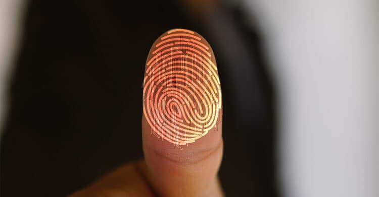 A close up of a fingertip shows a glowing digital fingerprint overlay, blending human identity with technology on a dark background. The image symbolizes authenticity, security, and uniqueness, supporting content about building trust and differentiation to Improve Your Brand in a digital world.