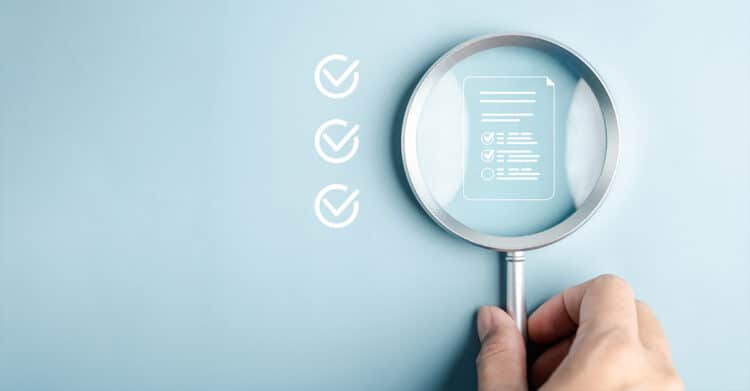 Is Your Blog Post Ready to Publish? A Complete Checklist 4 Hand holding a magnifying glass over a checklist document icon on a light blue background with three check marks beside it. This visual fits a Blog Post Ready workflow by suggesting final review, quality checks, and content approval before publishing.
