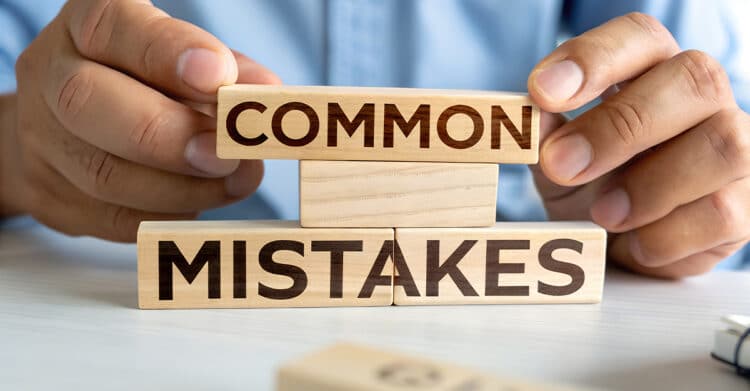 Is Your Blog Post Ready to Publish? A Complete Checklist 8 Hands stacking wooden blocks labeled "COMMON" and "MISTAKES" on a desk. This image works well in a Blog Post Ready article about catching common writing or editing errors before publishing.
