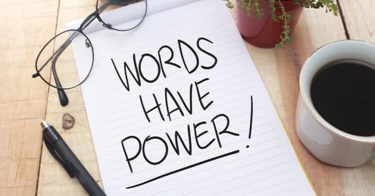 Effective Copywriting: The Core Pillars That Convert 8 Notepad on a wooden desk with eyeglasses, a pen, a coffee cup, and a small plant surrounding the handwritten message "WORDS HAVE POWER." The scene reinforces effective copywriting by highlighting how strong word choice can shape attention, emotion, and action.