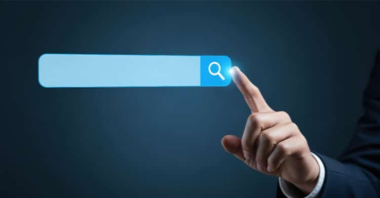 How Does Keyword Length Impact SEO Ranking? 5 A person in a dark suit is pointing at a glowing blue virtual search bar with a magnifying glass icon, symbolizing an online search or query. The futuristic interface suggests themes of digital technology, internet browsing, or SEO.