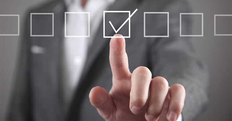 How Does Keyword Length Impact SEO Ranking? 6 A person in a business suit is pressing a virtual checkbox with a checkmark, surrounded by empty checkboxes in a horizontal line. The image conveys decision-making, task completion, or selection in a digital or business context.