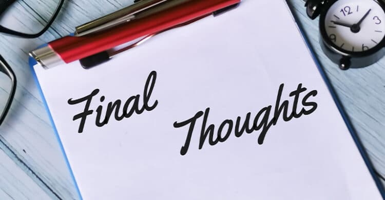 A clipboard holds a sheet of paper with the words “Final Thoughts” written in cursive, surrounded by pens, eyeglasses, and a small clock on a light wooden surface. The image symbolizes reflection, conclusions, or wrap-up at the end of a discussion or project.