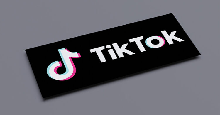 TikTok logo displayed on a sleek black background, representing the app's bold and modern branding.
