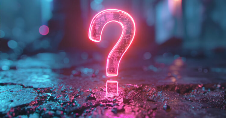 A glowing neon pink question mark standing on a dark, wet, and reflective urban surface, with blurred lights in the background.