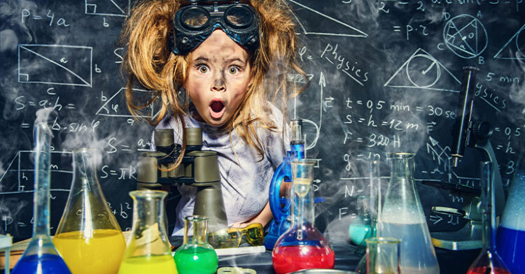 A surprised child wearing goggles surrounded by colorful chemical-filled beakers, with physics equations on a chalkboard in the background.
