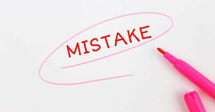 A red word “MISTAKE” is circled with pink marker on a white background, with the uncapped pink marker lying beside it. This image highlights the concept of errors, making it a fitting visual for discussing common mistakes in social media promotion.