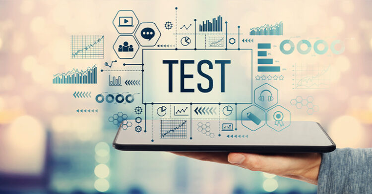 Tablet held by a hand with “TEST” in bold letters on the screen, surrounded by various data-related icons, charts, and analytics graphics on a blurred background.