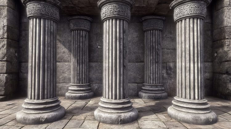 Five ancient stone columns with intricate carvings on their capitals, standing in a grand, weathered structure with a stone floor and walls.