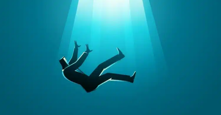 Silhouette of a man in a suit falling downward in a deep blue space with light streaming from above.