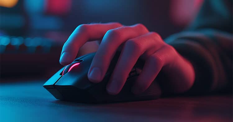 Close-up of a person's hand on a gaming mouse in a neon-lit environment, highlighting user engagement and digital interaction behaviors.