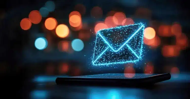 A digital representation of an email envelope hovers above a smartphone screen, against a bokeh background.