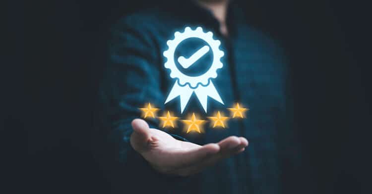 A person holds out a hand with a glowing digital badge and five gold stars floating above it, symbolizing trust and high-quality reputation.