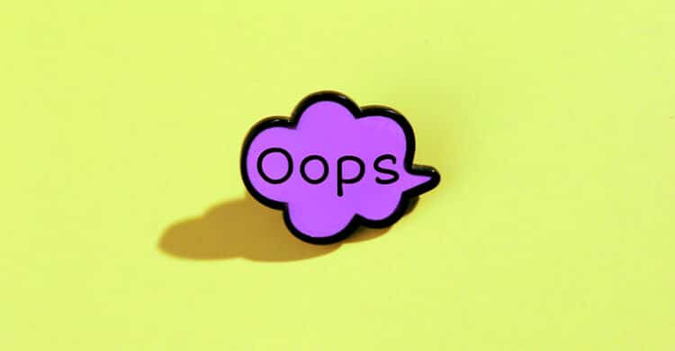 Purple speech bubble pin with the word “Oops” in black text, set against a bright yellow background. The playful design and bold colors give the image a lighthearted tone, suggesting a minor mistake or accident.