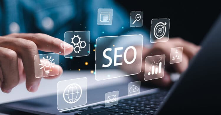 Hands hovering over a laptop with glowing digital icons surrounding a central screen that reads SEO. This concept graphic represents SEO strategy through symbols for analytics, settings, search, targets, and web visibility.