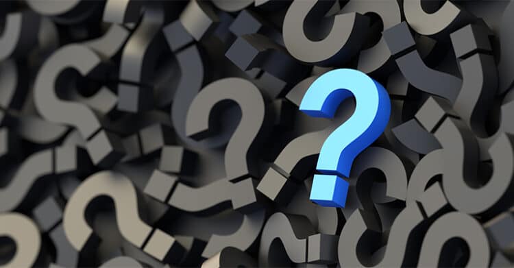 Alt text: Cluster of dark question marks fills the background with one bright blue question mark standing out in the center. This graphic supports content about how to increase social media engagement by highlighting curiosity and the kinds of questions that prompt people to stop, respond, and join the conversation.