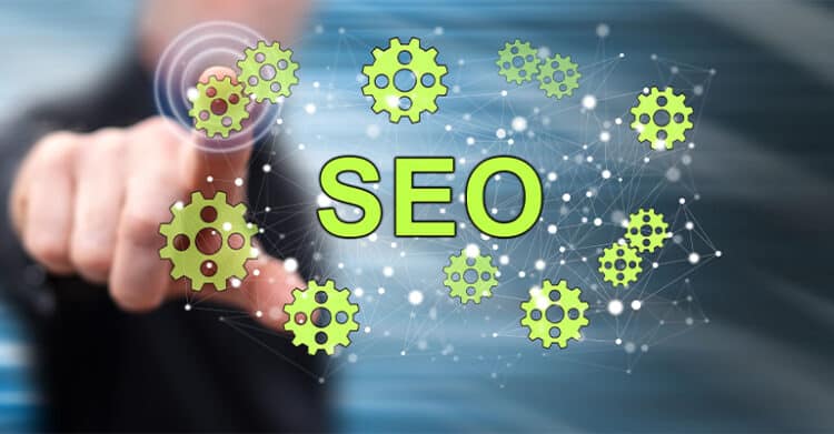 Hand pressing a virtual interface with the word "SEO" in large green letters surrounded by connected gear icons, illustrating technical SEO systems and search optimization processes.