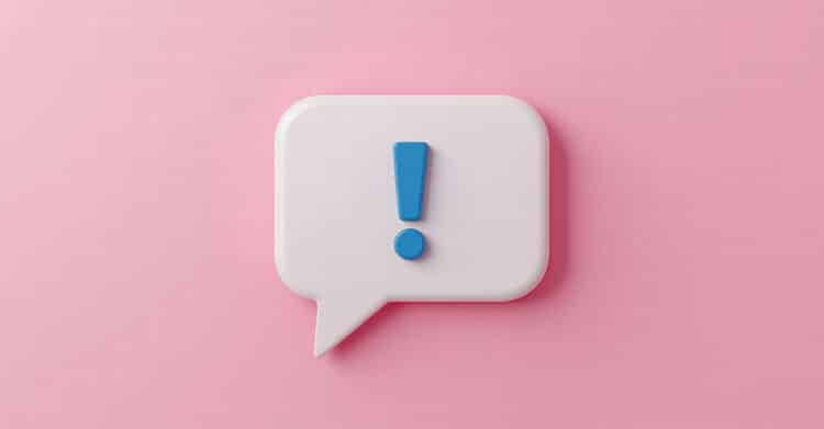 White speech bubble with a blue exclamation mark on a pink background, representing important social media marketing tips and frequently asked questions.
